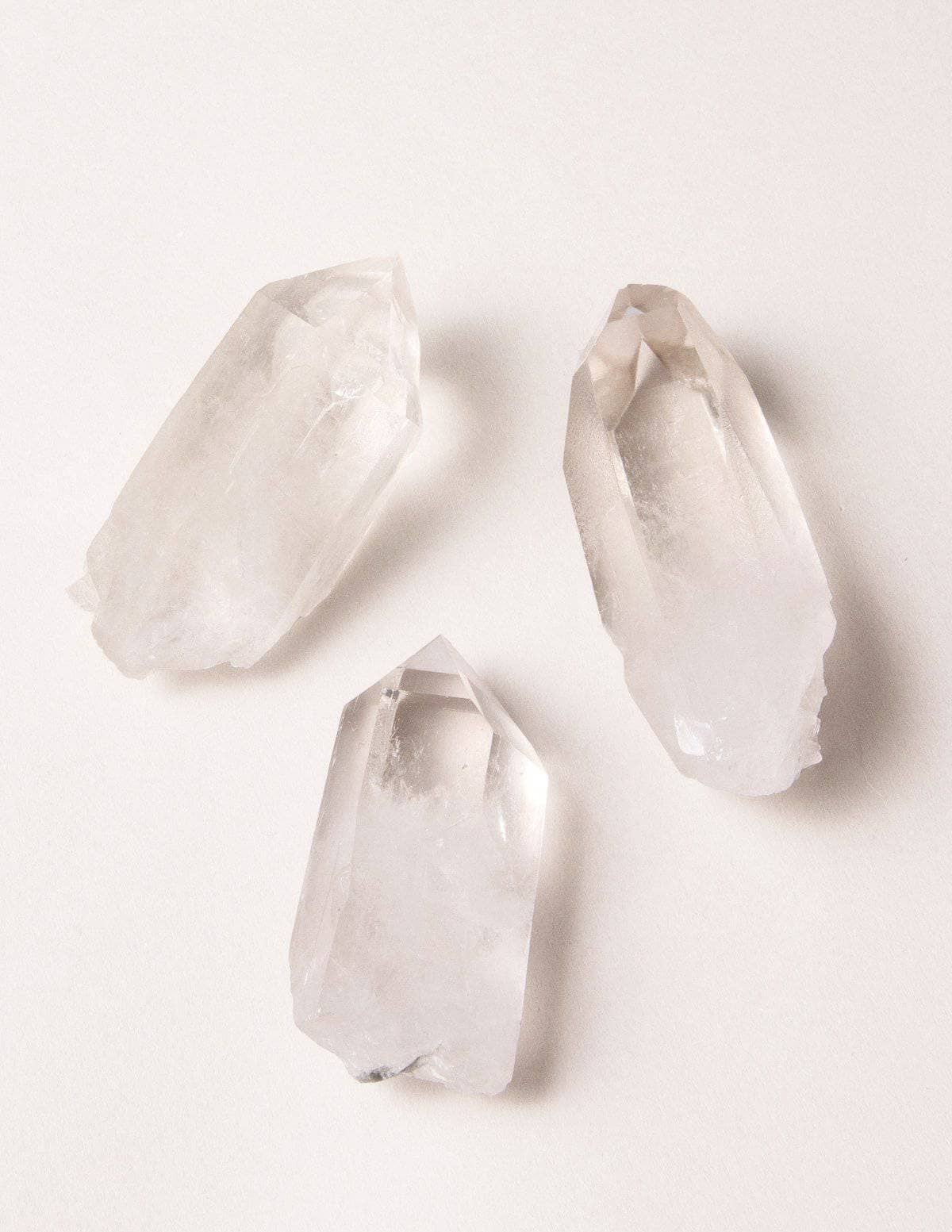 three clear quartz points white background